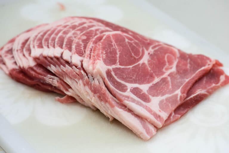 Raw meat on a white cutting board