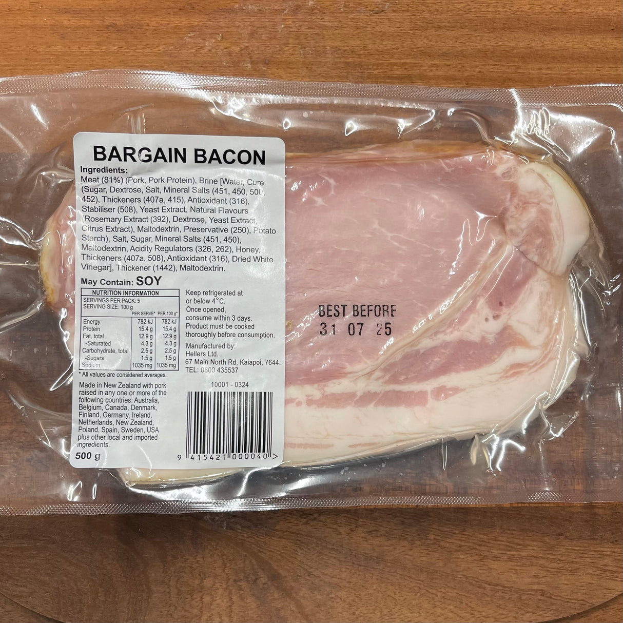 Packaged bacon with a label on a wooden surface