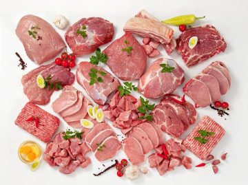 Raw meat assortment, fresh vegetables and culinary herbs